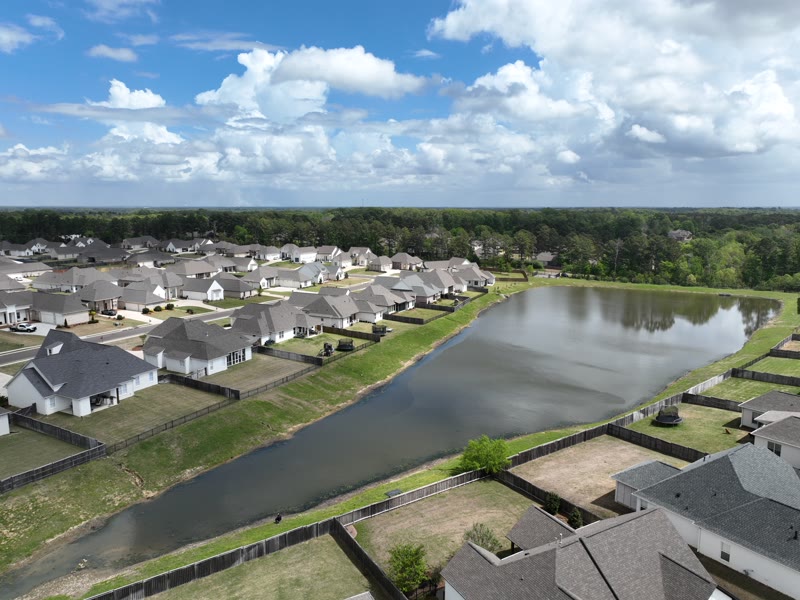 Aerial view of homes along the community pond
